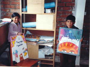 two children holding large Spanish books