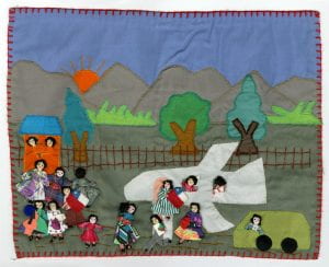 Detail from a patchwork quilt showing a sad airport scene as families and individuals were forced to flee Chile because of political persecution.