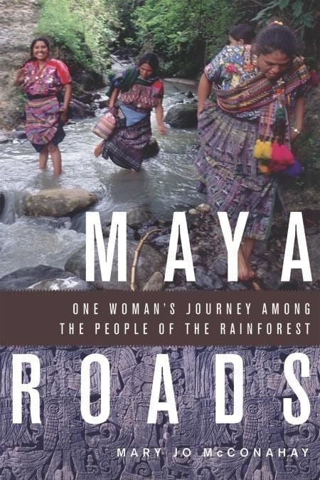 Photo of cover of book Maya Roads, One Woman’s Journey Among the People of the Rainforest, showing three indigenous women in a stream.