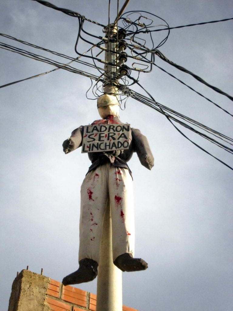 A lynched effigy with a warning sign that reads 