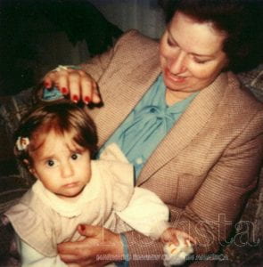 Phot of the article's author Laura Barragán Montaña as a young child in the lap of her grandmother. Photo courtesy of Laura Barragán Montaña