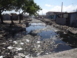Photo of the polluted canal in Cité Féquiére, the poorest neighborhood within the Cité Soliel slum of Haiti.