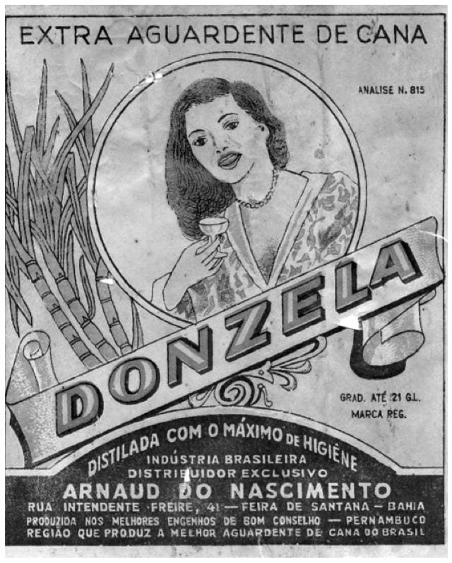 This label from a cachaça (firewater) bottle is a classic from Pernambuco. Image from James Ito-Adler's Cachaca Bottle Label-Collection. It features a woman with a small glass in her hand, and sugar canes to the side.