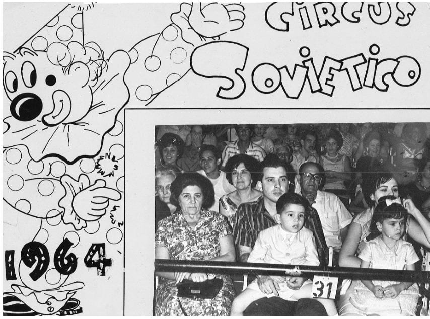 A poster for the soviet circus performing in Cuba in 1964, with an inset of a photo of a family watching the circus, with two young children in their parents' laps.