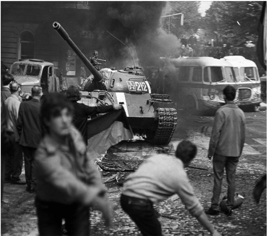 As the soviet-led invasion by the warsaw Pact armies crushed the so called Prague spring reform in former Czechoslovakia, Prague residents carrying a Czechoslovak flag and throwing burning torches attempt to stop a soviet tank, August 21, 1968.